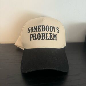 Black and Cream “Somebody’s Problem” Trucker Hat